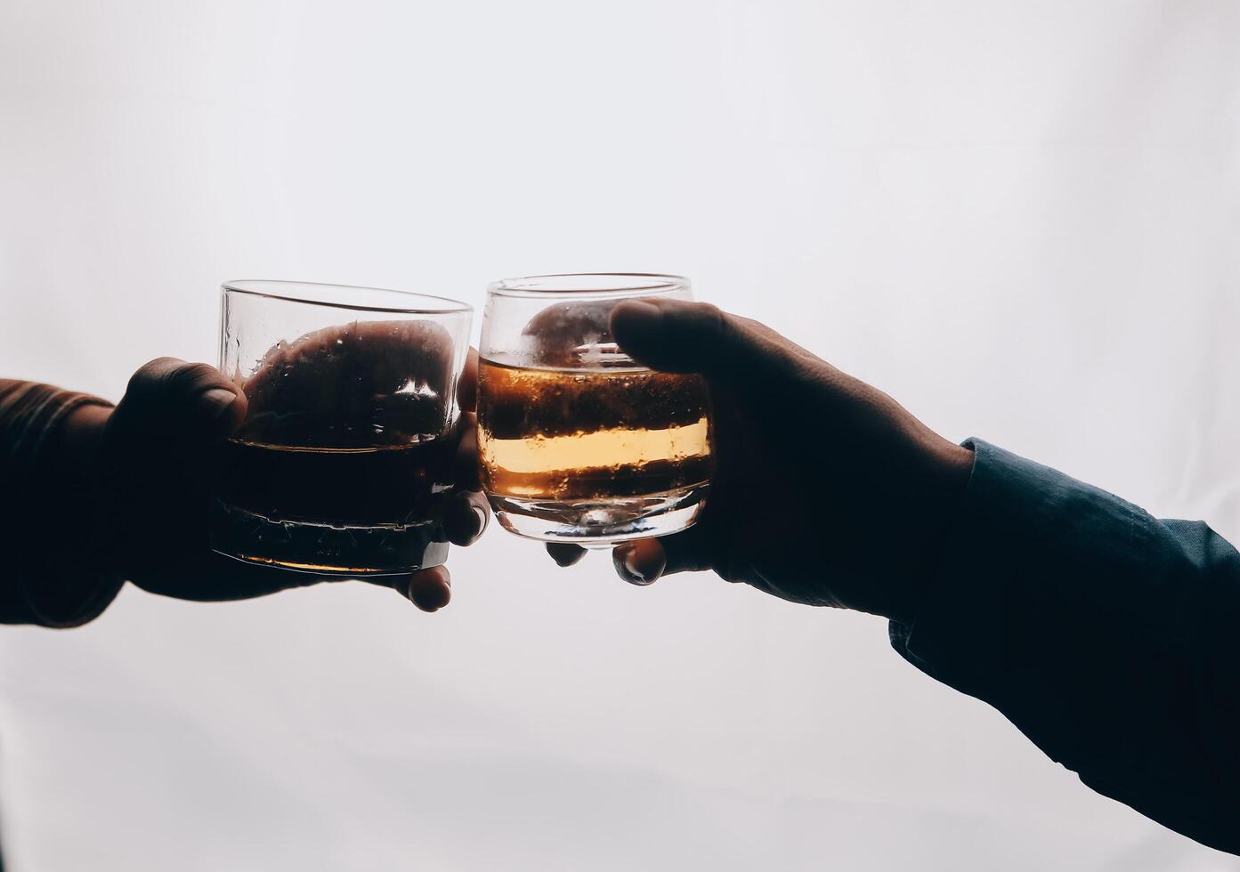 Whiskey splashing out of glass, isolated on white background photo