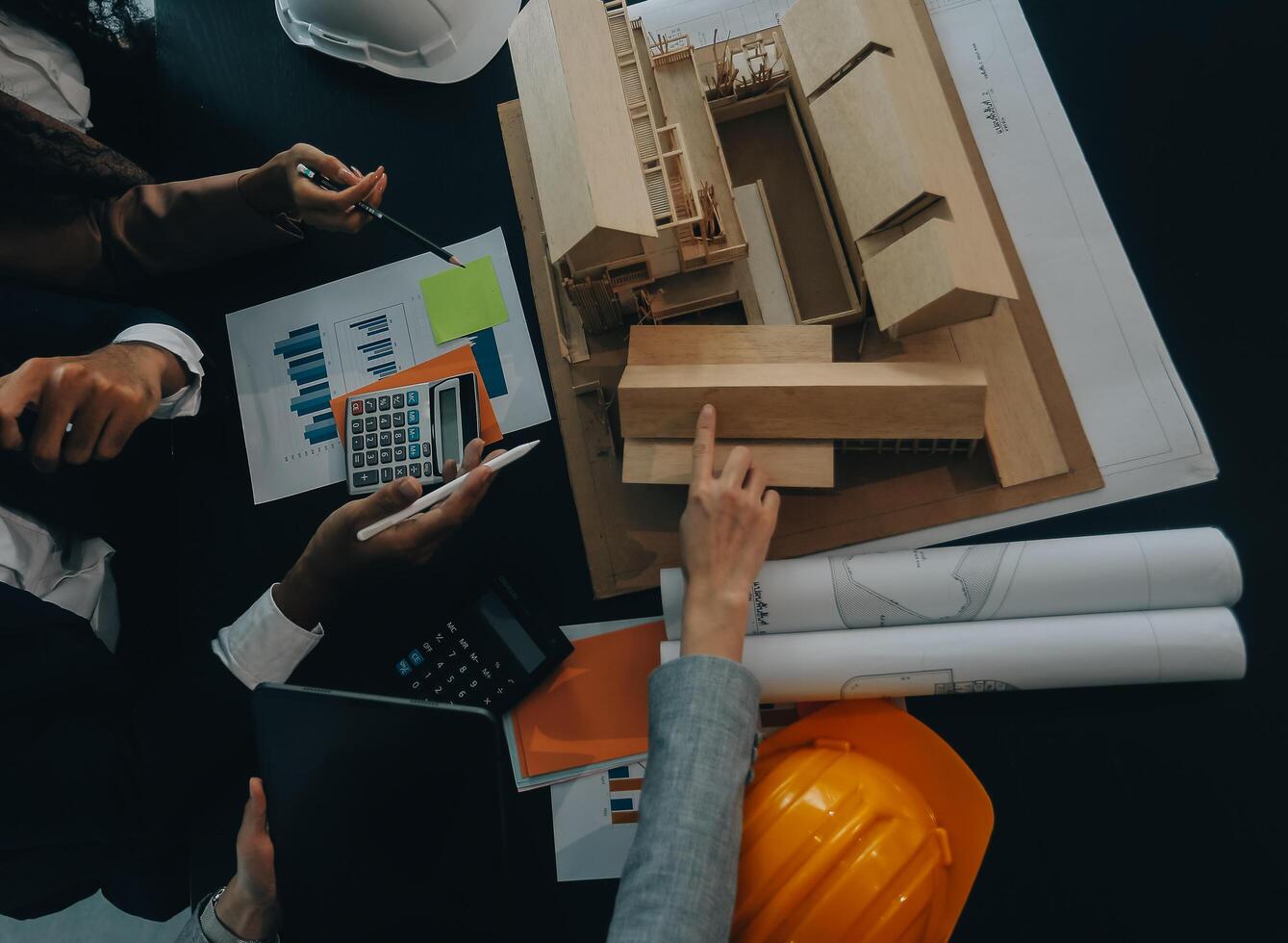 Engineer Teamwork Meeting, Drawing working on blueprint meeting for project working with partner on model building and engineering tools in working site, Construction and structure concept. photo