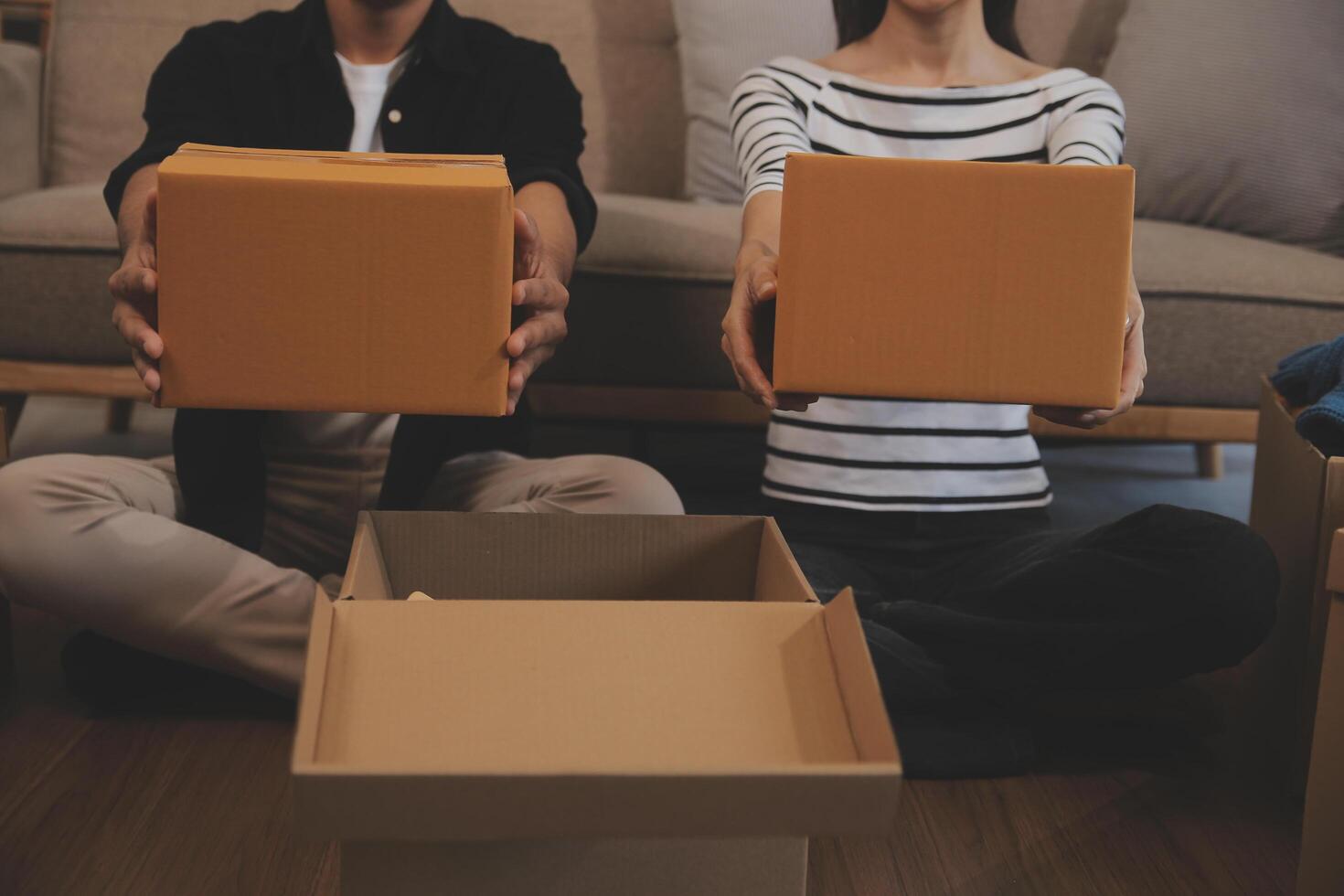 Two Asian blogger showing clothes in front of the camera to recording vlog video live streaming at her shop. Online Shopping Cart notion. on sofa at home photo