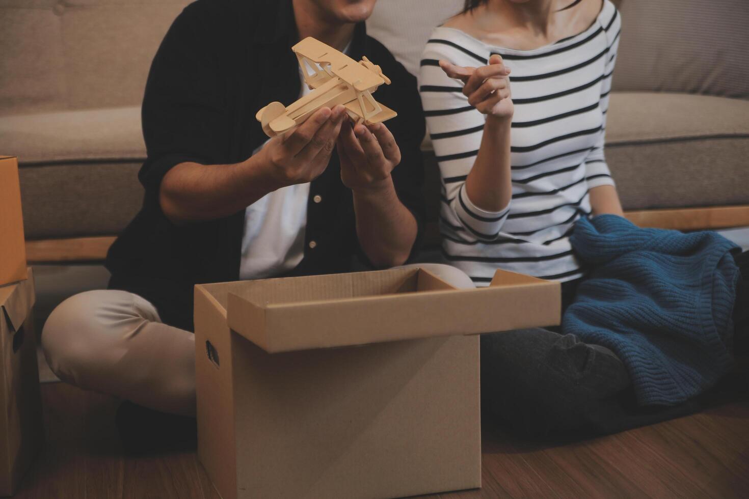 Two Asian blogger showing clothes in front of the camera to recording vlog video live streaming at her shop. Online Shopping Cart notion. on sofa at home photo