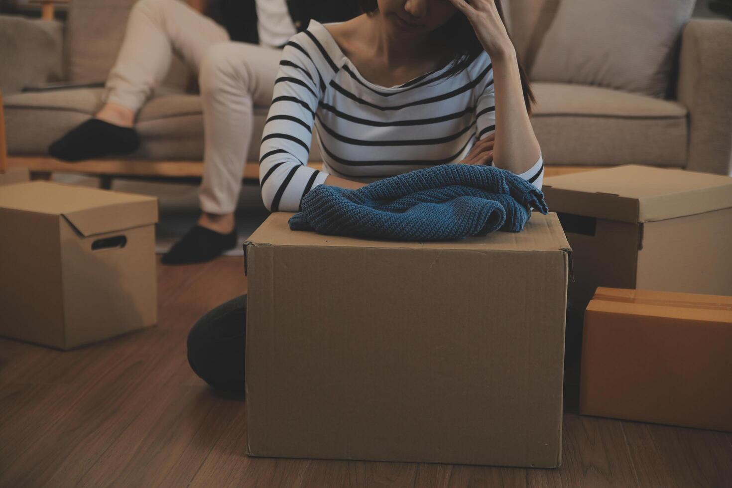 Two Asian blogger showing clothes in front of the camera to recording vlog video live streaming at her shop. Online Shopping Cart notion. on sofa at home photo