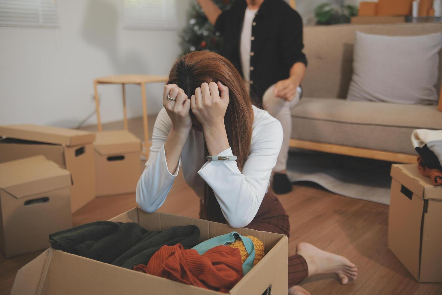 Two Asian blogger showing clothes in front of the camera to recording vlog video live streaming at her shop. Online Shopping Cart notion. on sofa at home photo