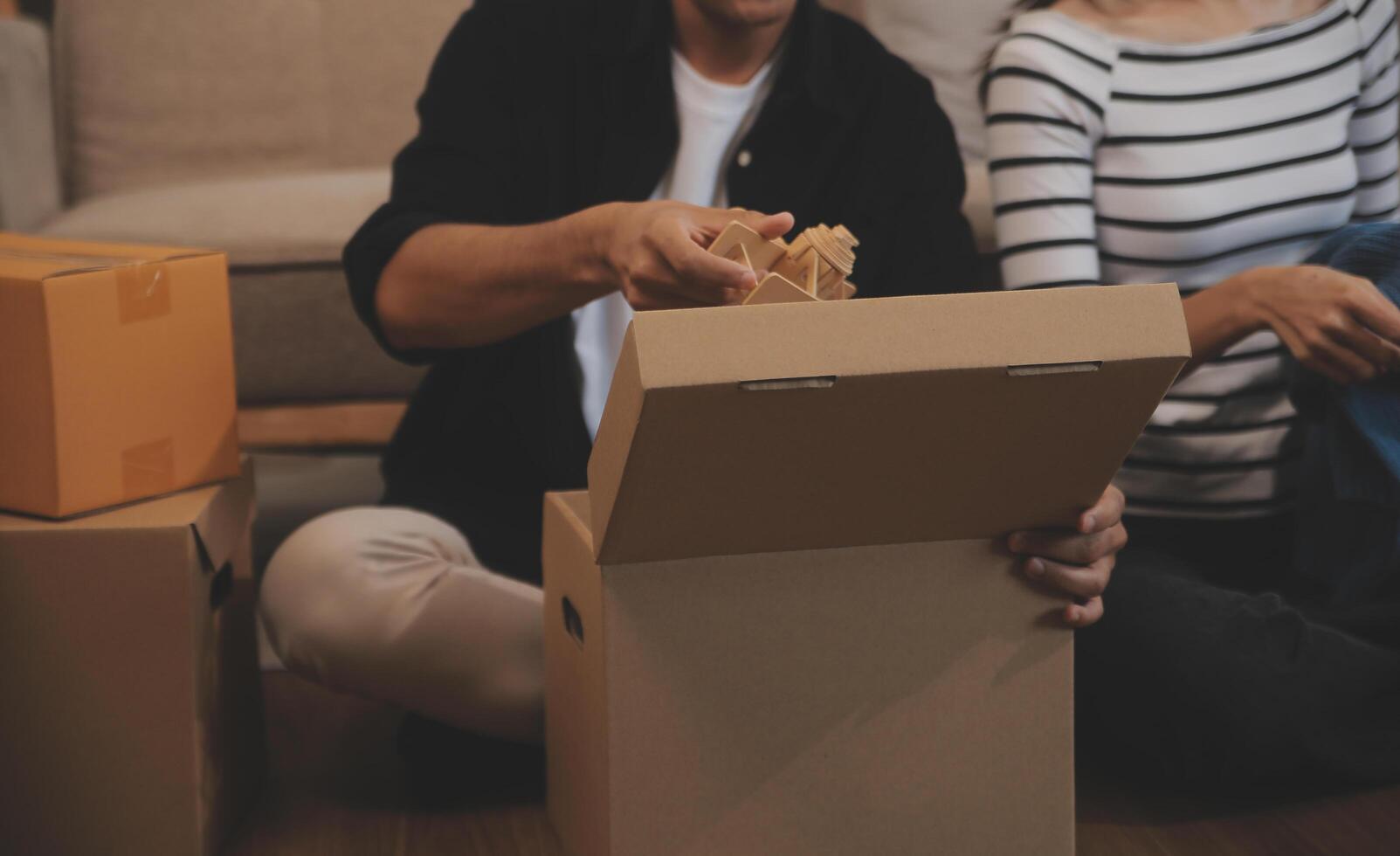 Two Asian blogger showing clothes in front of the camera to recording vlog video live streaming at her shop. Online Shopping Cart notion. on sofa at home photo