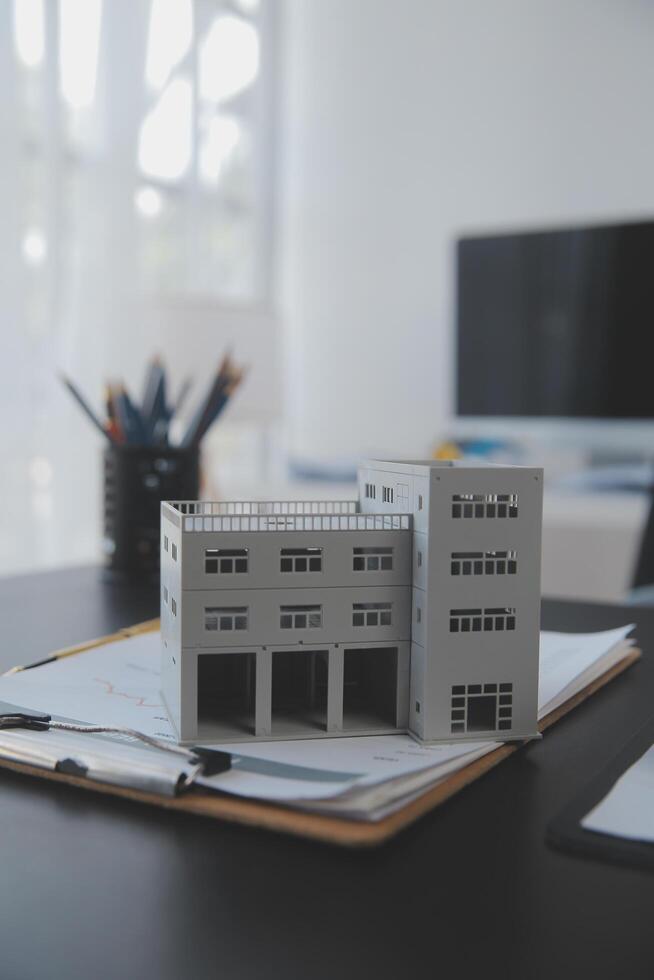 Real estate agent and Sales manager team analysis pricing of rental lease contract of sale purchase agreement, concerning mortgage loan offer for and house insurance. photo