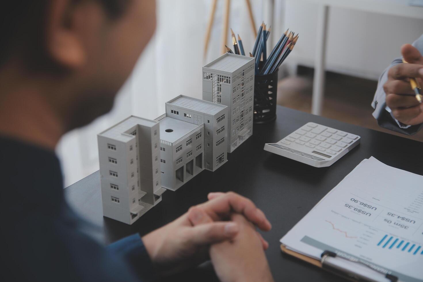 Real estate agent and Sales manager team analysis pricing of rental lease contract of sale purchase agreement, concerning mortgage loan offer for and house insurance. photo