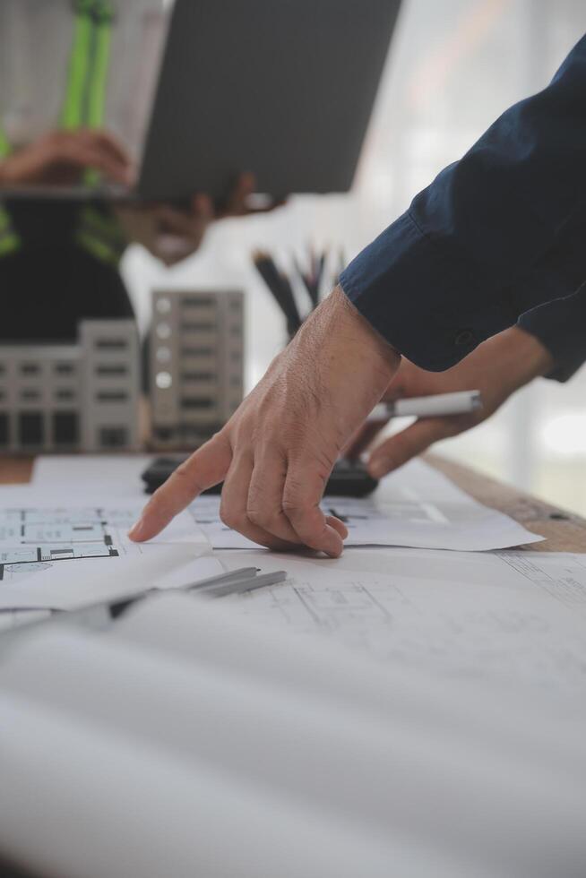 Construction and structure concept of Engineer or architect meeting for project working with partner and engineering tools on model building and blueprint in working site, contract for both companies. photo