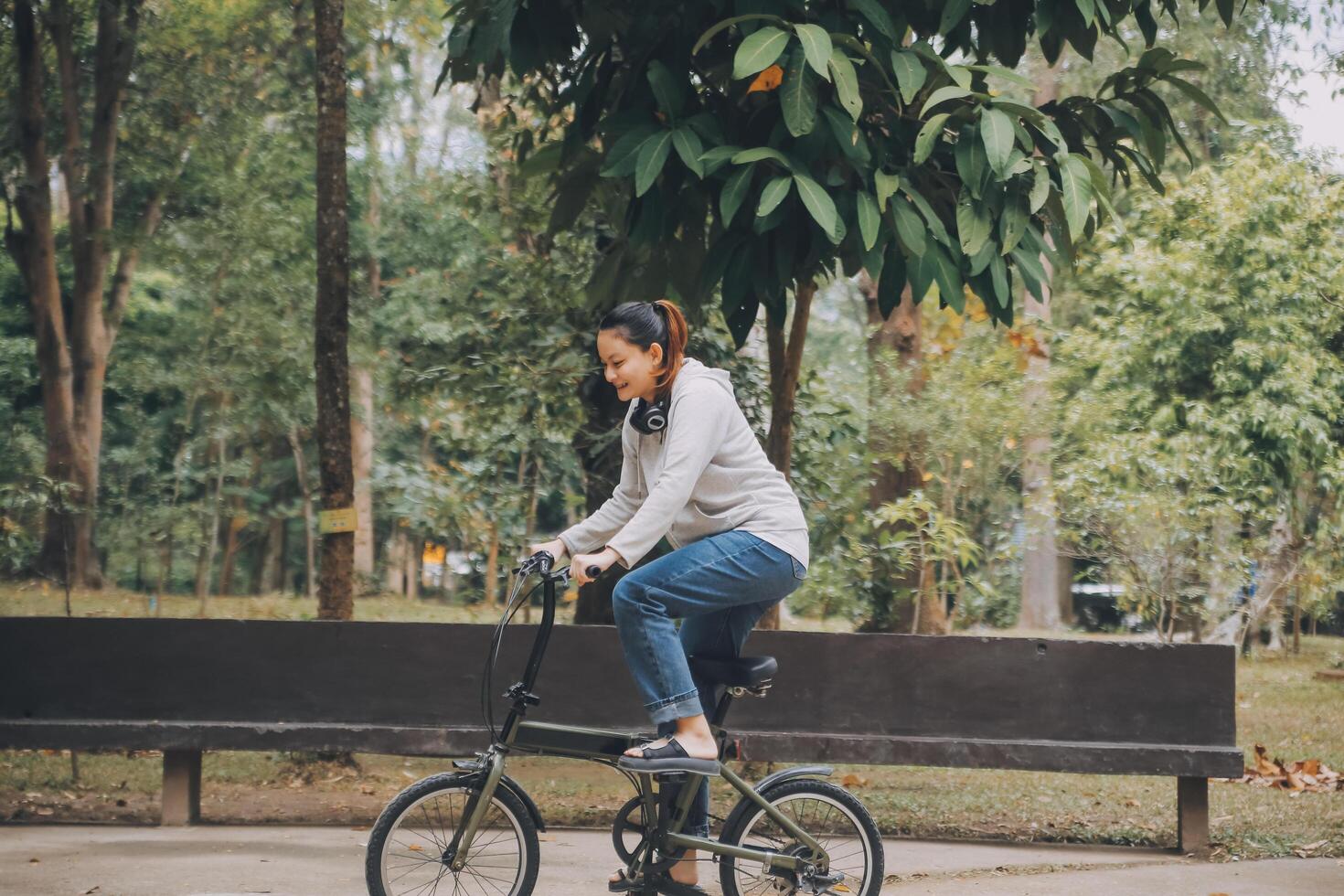 Happy Asian young woman walk and ride bicycle in park, street city her smiling using bike of transportation, ECO friendly, People lifestyle concept. photo