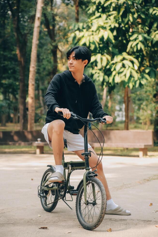 Handsome happy young man with bicycle on a city street, Active lifestyle, people concept photo