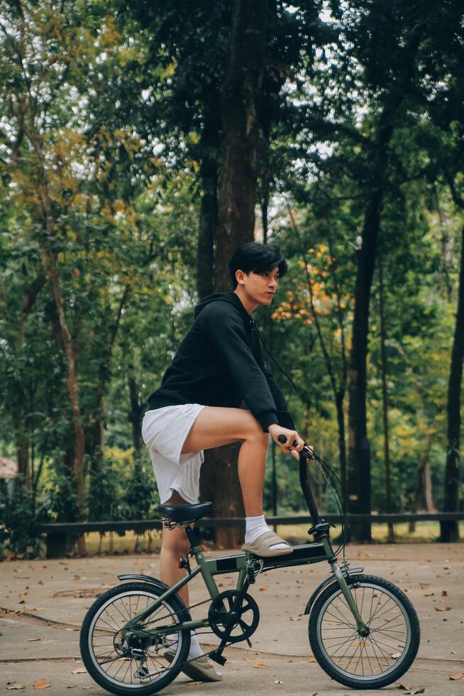 Handsome happy young man with bicycle on a city street, Active lifestyle, people concept photo