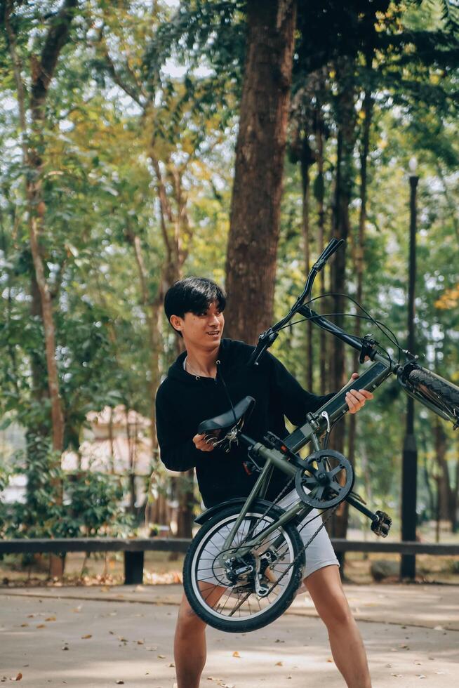 Handsome happy young man with bicycle on a city street, Active lifestyle, people concept photo