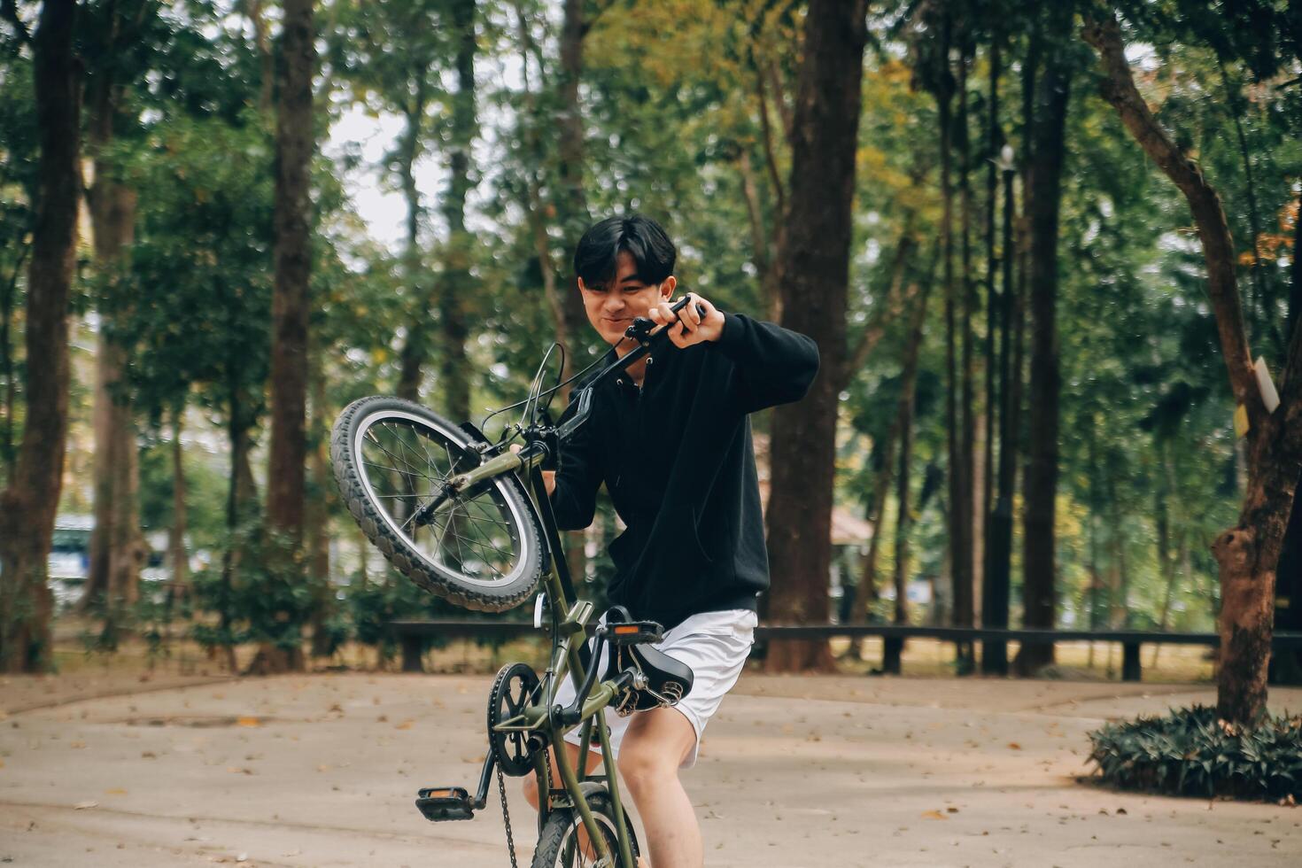 Handsome happy young man with bicycle on a city street, Active lifestyle, people concept photo