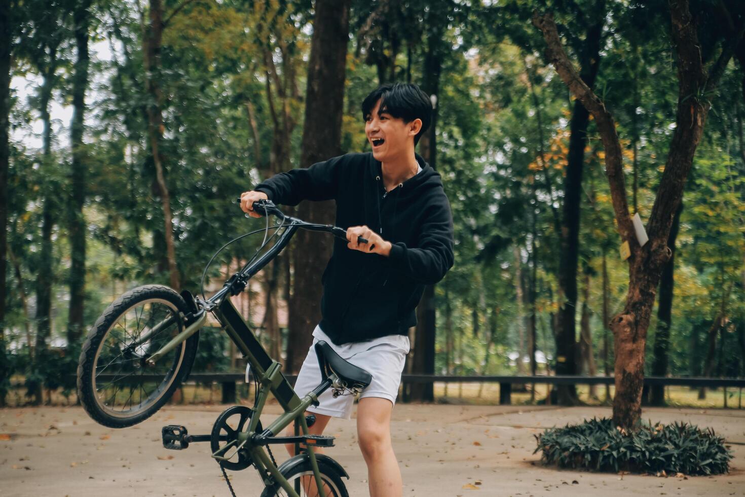 hermoso contento joven hombre con bicicleta en un ciudad calle, activo estilo de vida, personas concepto foto