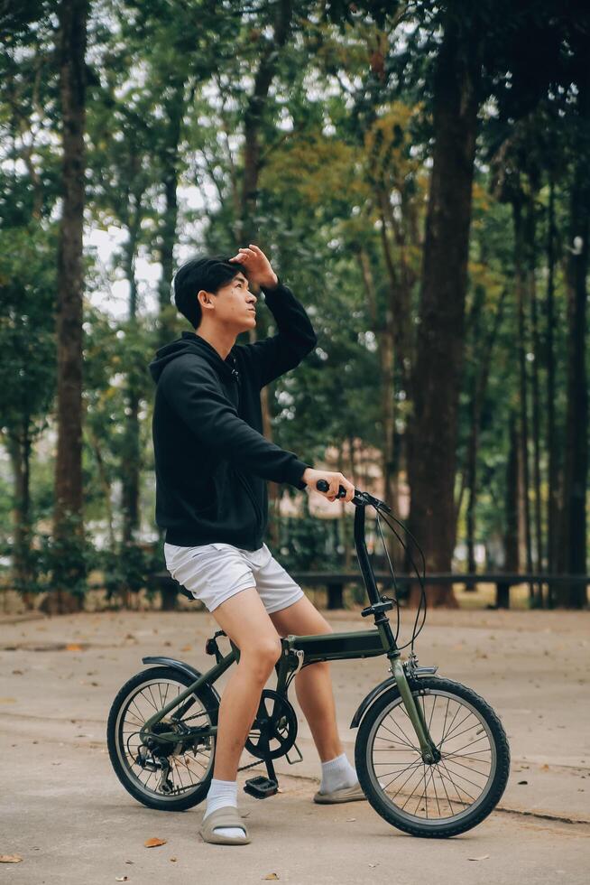 Handsome happy young man with bicycle on a city street, Active lifestyle, people concept photo