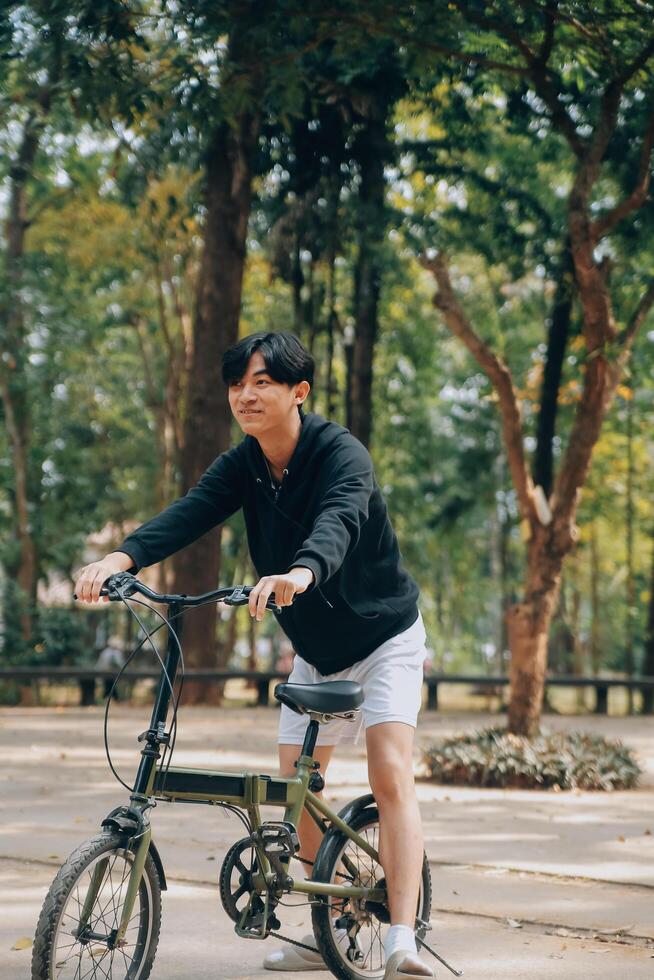 Handsome happy young man with bicycle on a city street, Active lifestyle, people concept photo