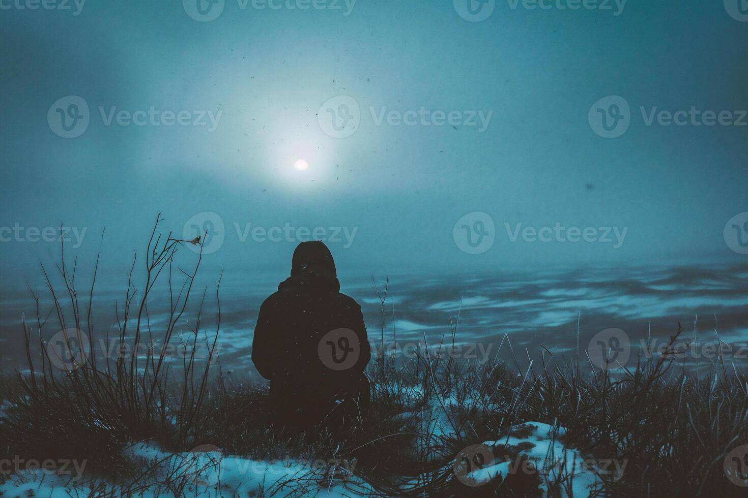 AI generated Silhouette of a man sitting on the top of a mountain and looking at the moon photo