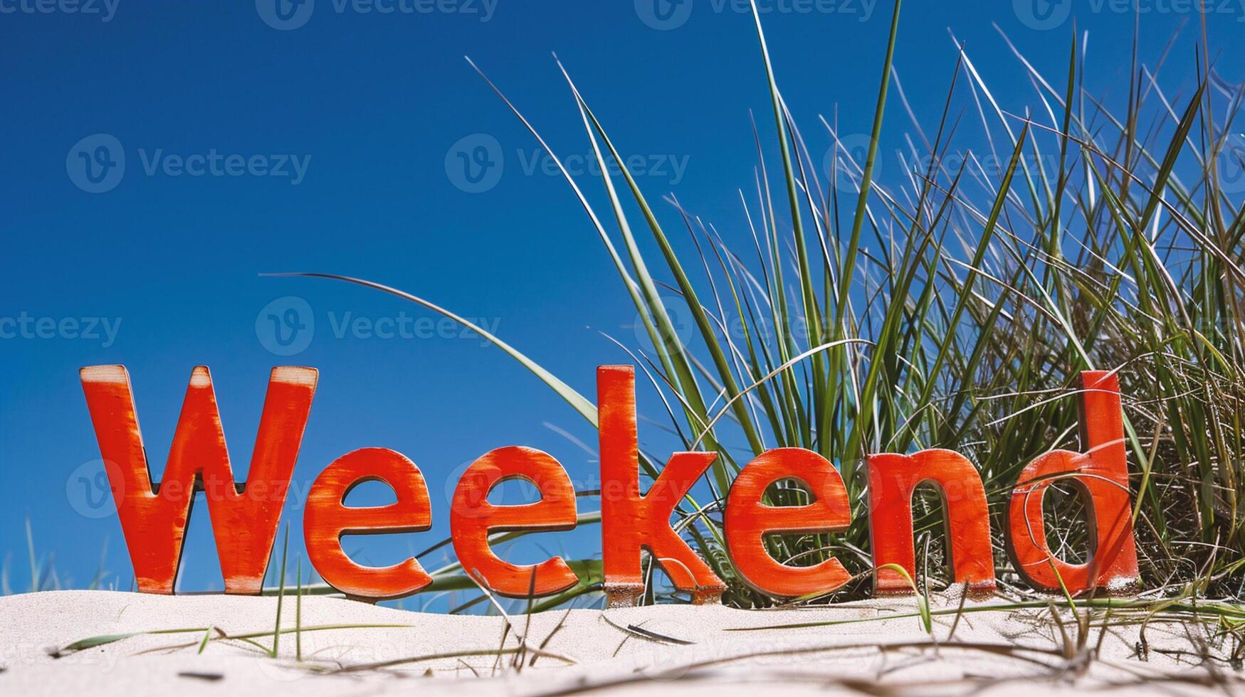 AI generated The word Weekend is written in red letters on the sand photo