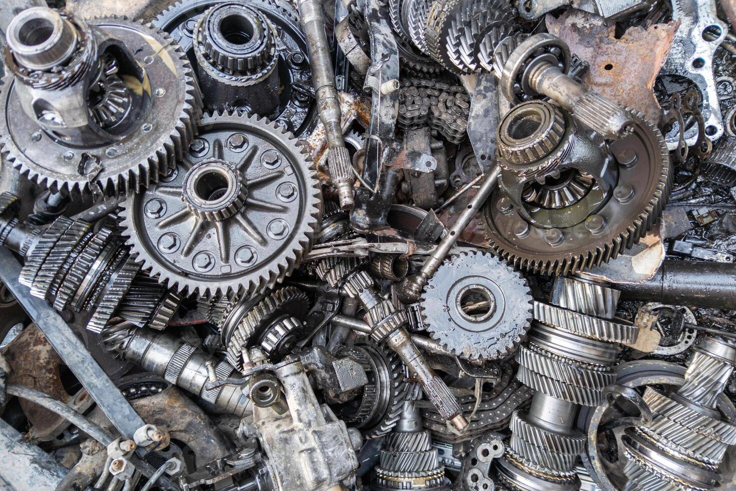 pile of used car transmission gears, full-frame close view background photo