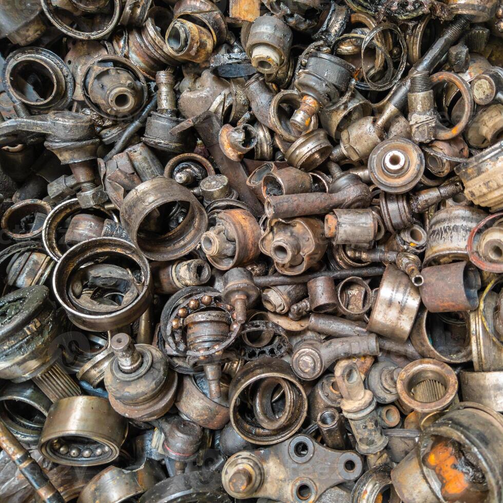 rusted steel scrap pile of used car parts and pieces photo