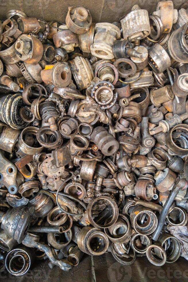 rusted steel scrap pile of used car parts and pieces photo