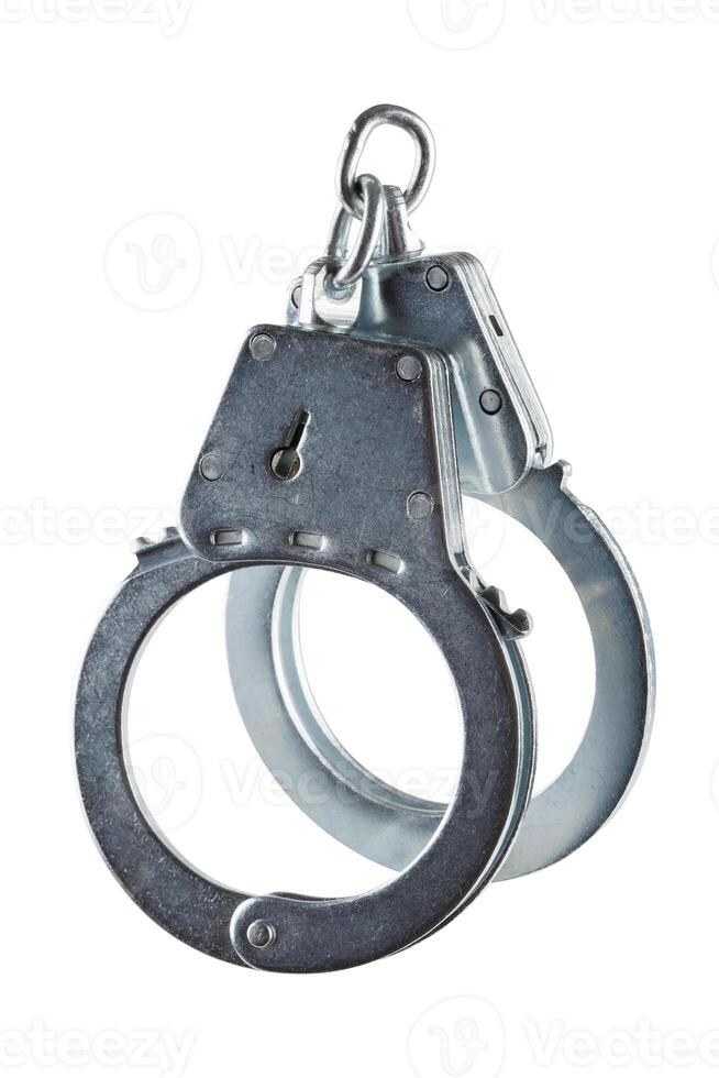 real zinc plated steel police handcuffs closed, isolated on white background photo