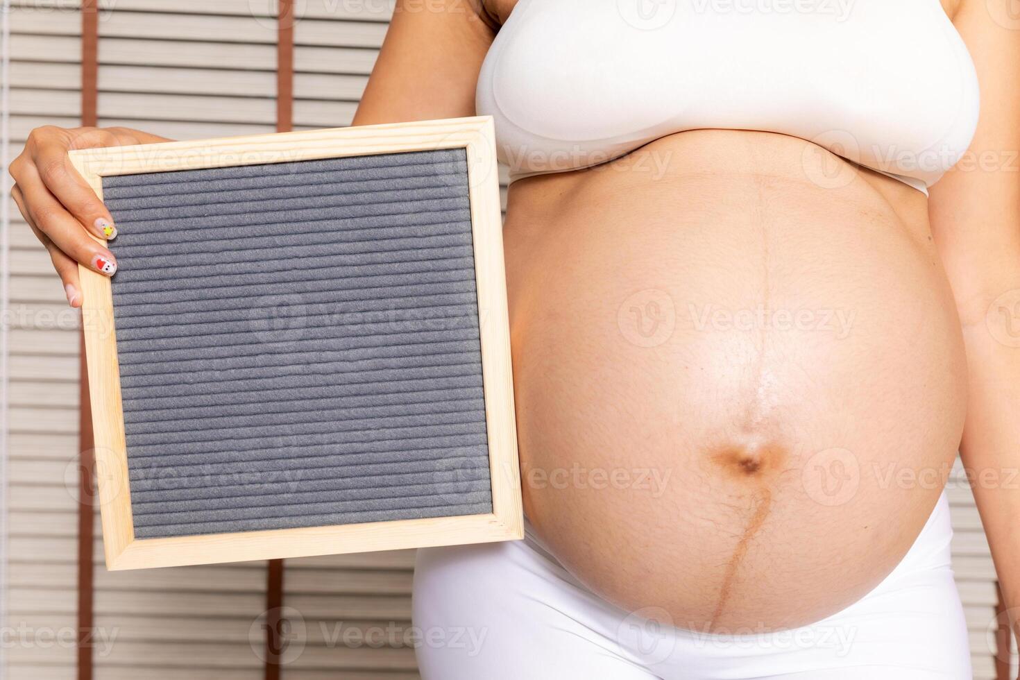 Big pregnant woman with Letter Board photo