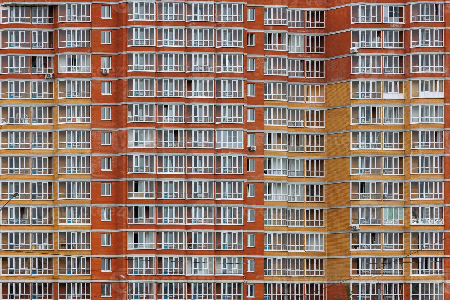 large russian cheap apartment building wall with enormous quantity of windows, full-frame background and texture photo