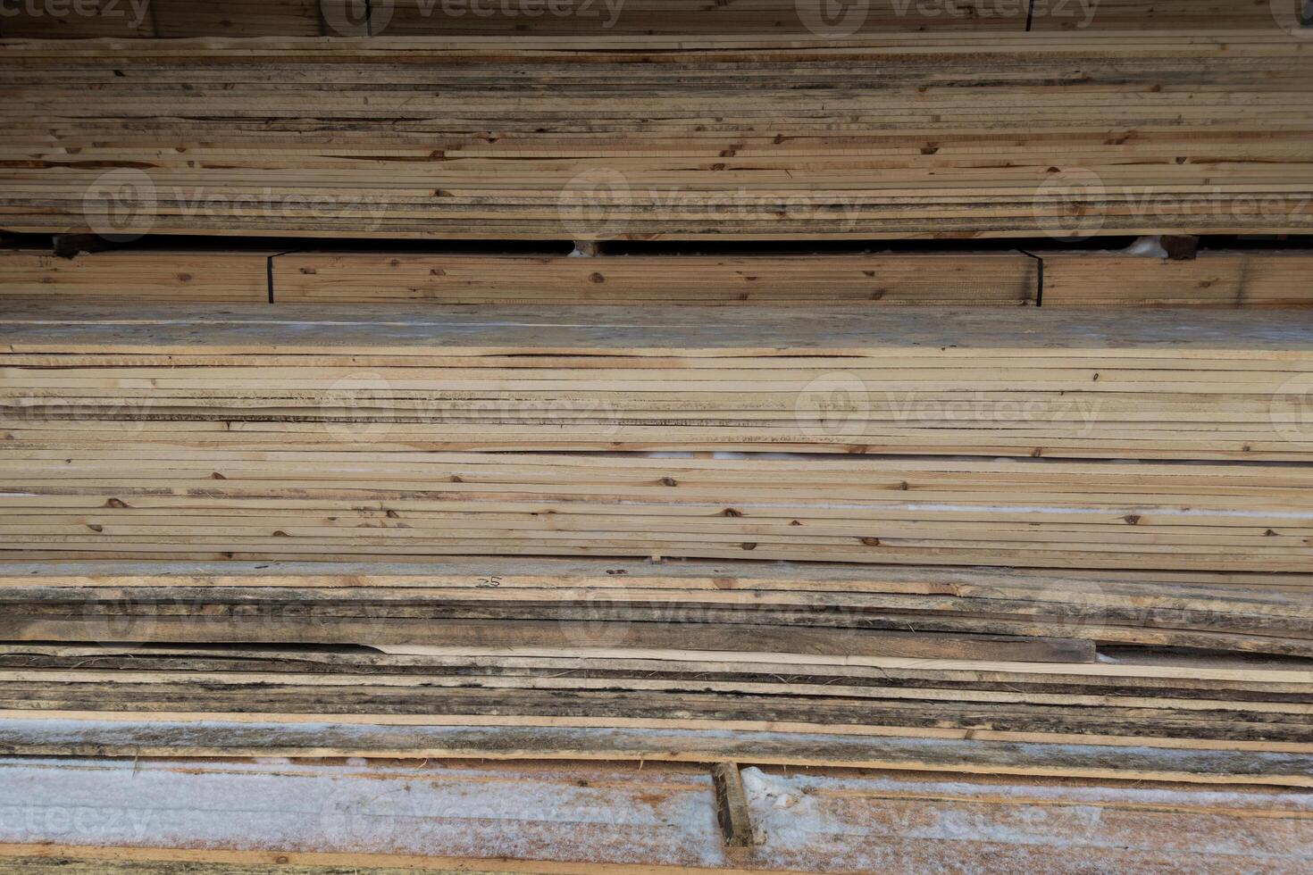 wooden boards storage under a canopy with snow and metled ice on the floor photo