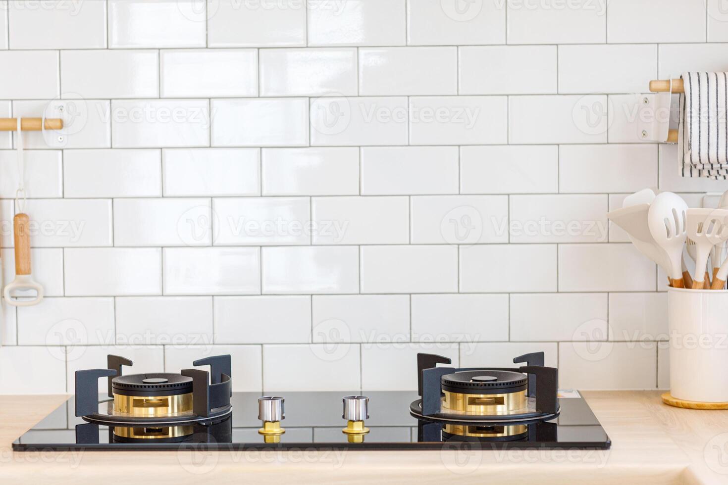 minimalist kitchen. Selective focus on gas stove appliance and countertop surface with blurred kitchenware photo