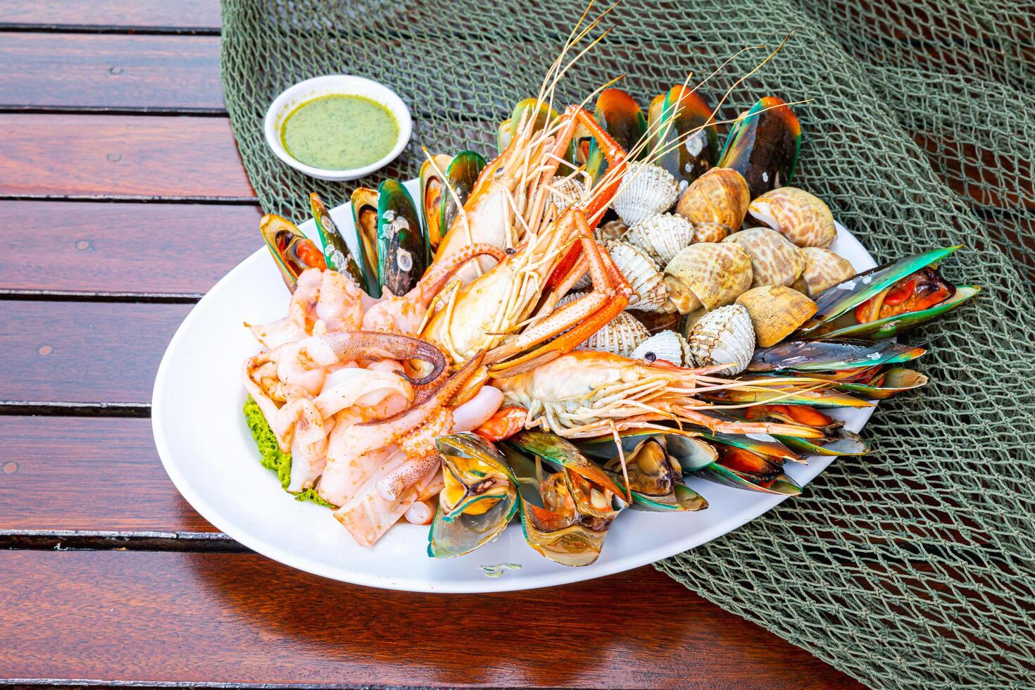 Seafood prawns, prawns, mussels, clams on plate and dark background cooked food photo
