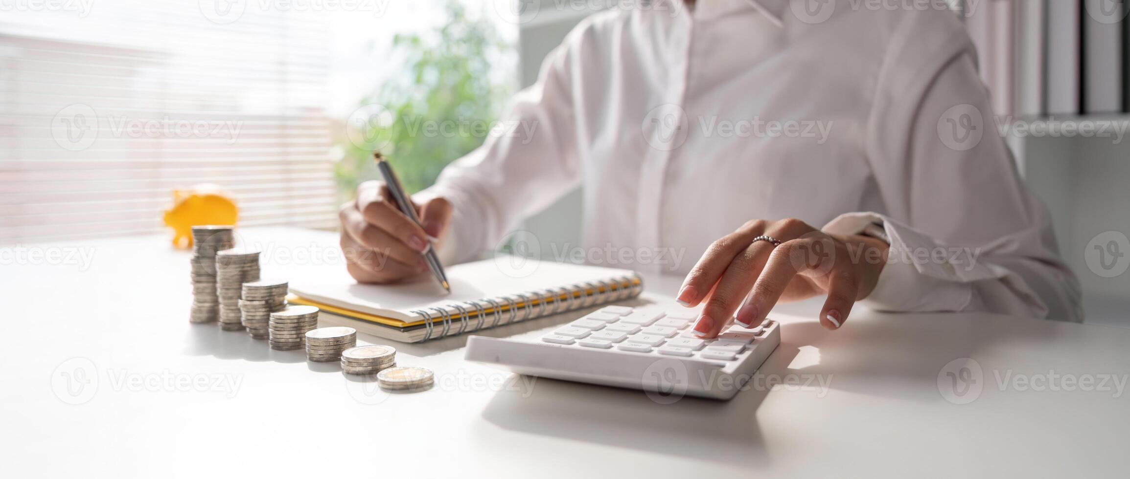 Saving money wealth concept, asian young woman hand write management budget for saving cost, cash finance plan to spend enough money on her income for save money, payment tax, investing photo