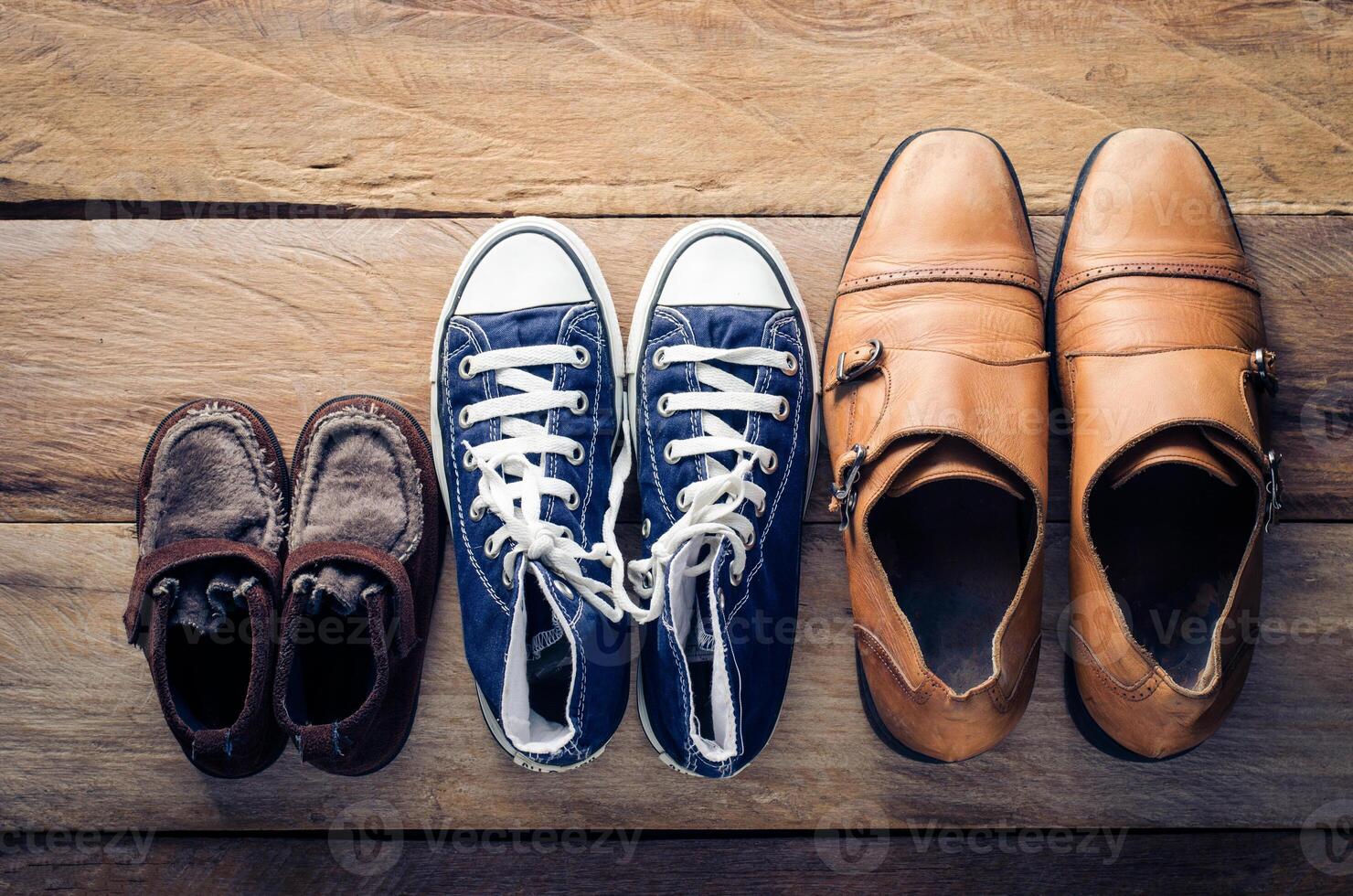 Three pairs of shoes, three stages of the growth. photo