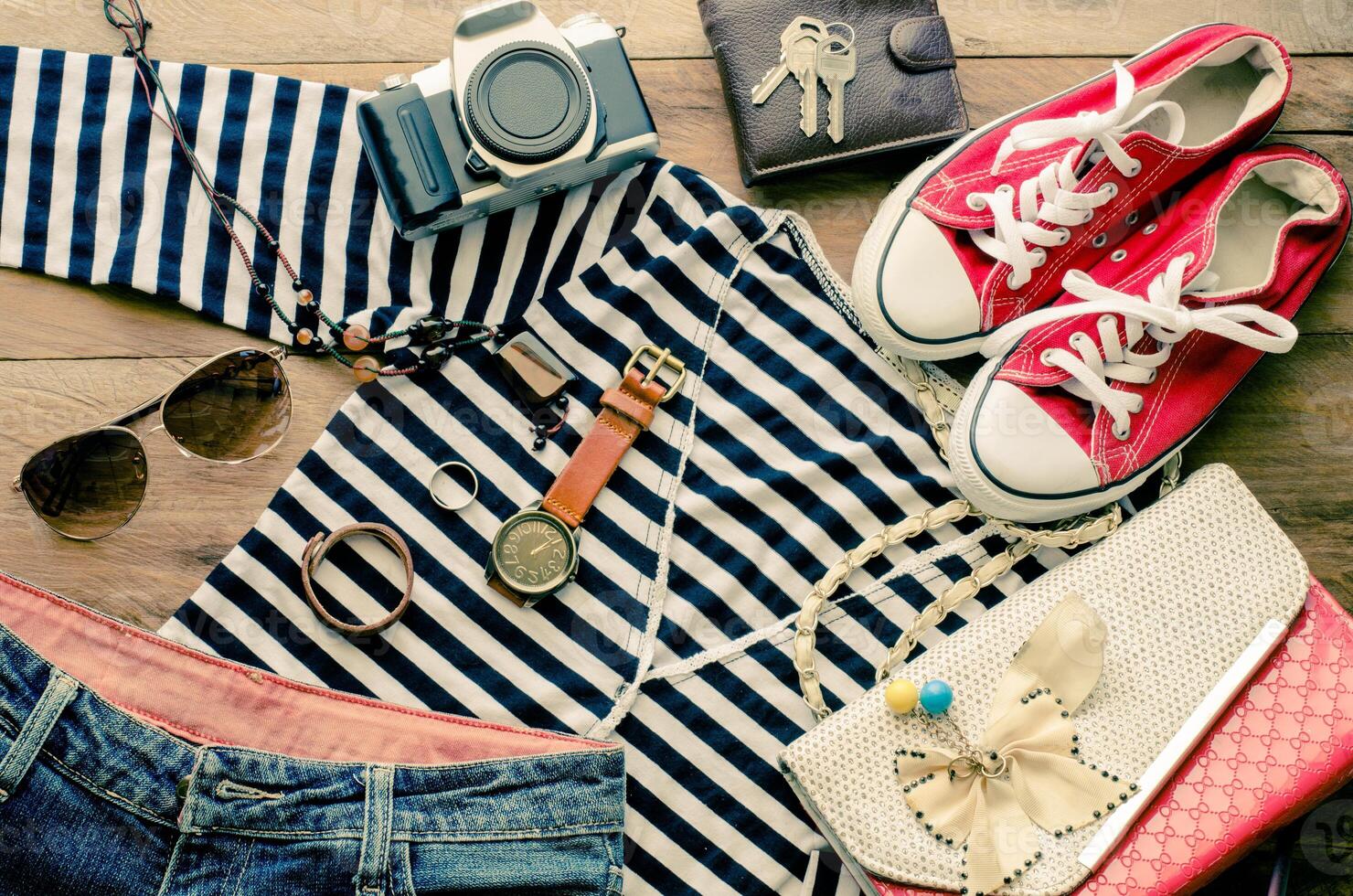 Travel accessories and costume on wooden floor photo