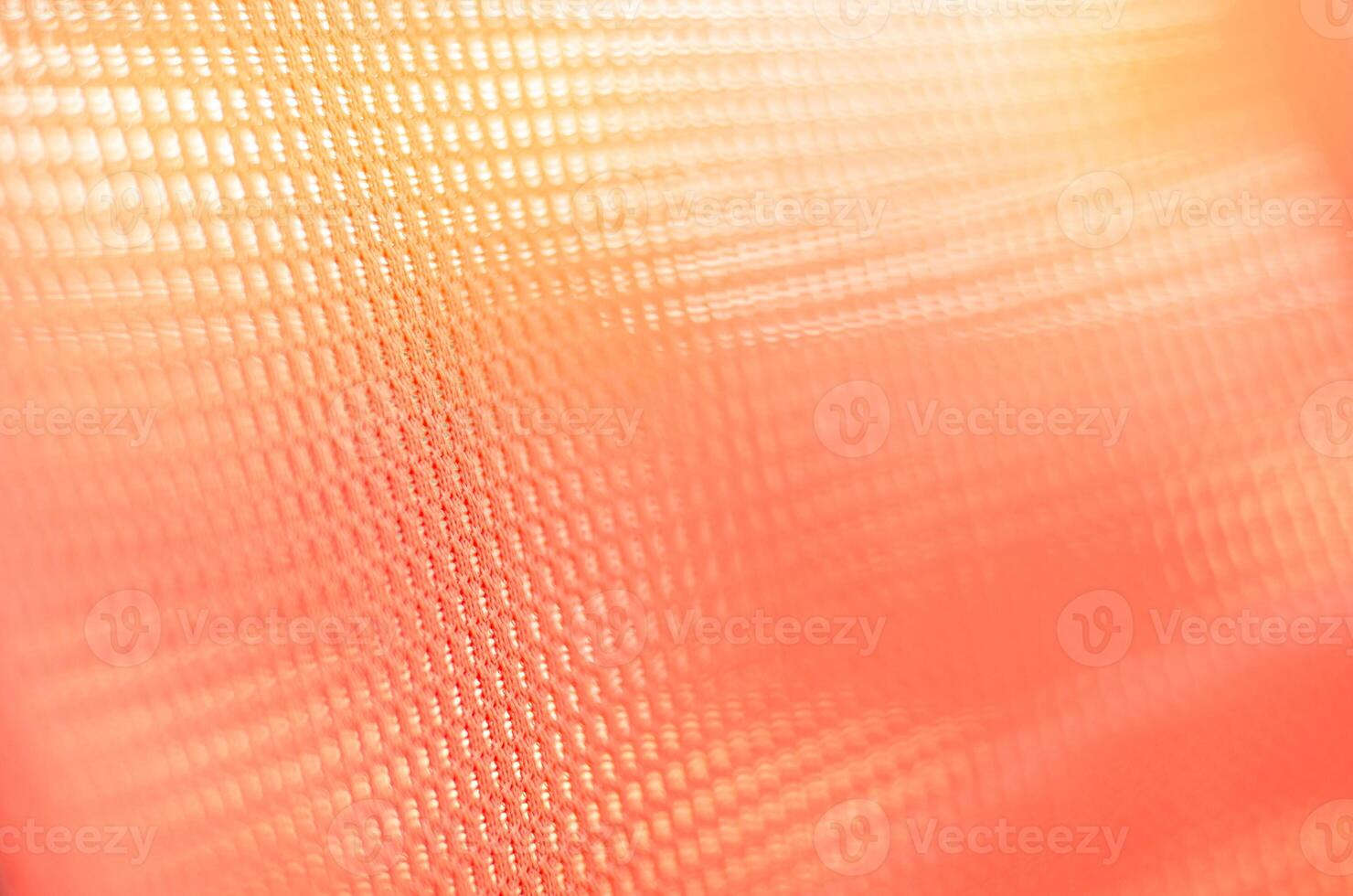fabric orange colored background with light penetrating through fabric orange colored background with light penetrating through photo