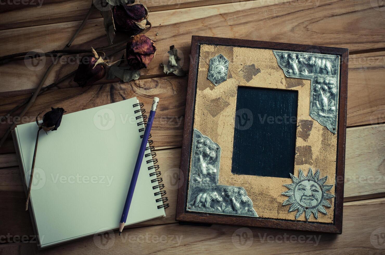 Still life picture frames, vases, dried rose notebook concept frequent memories. photo