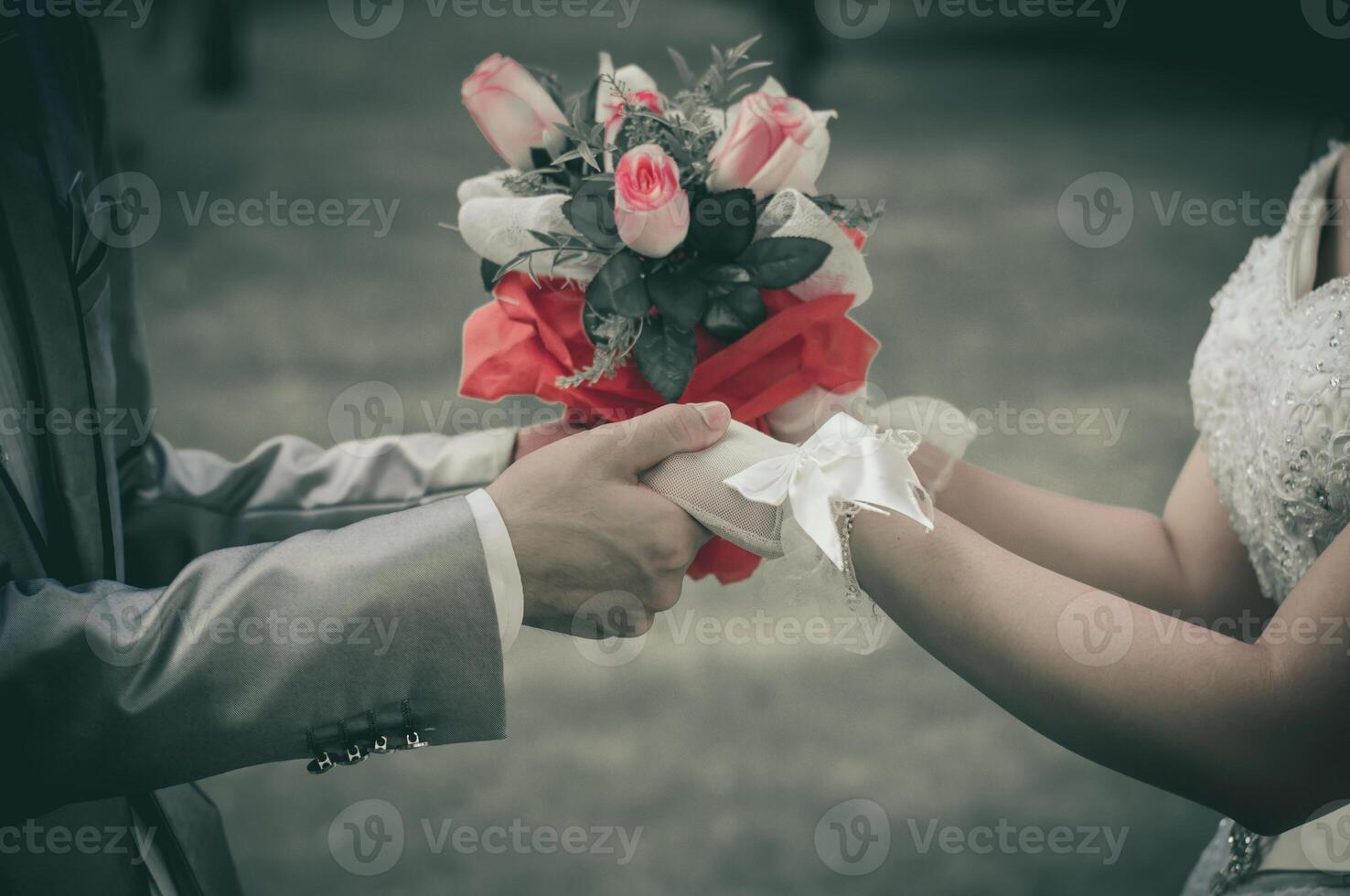 Bride and groom wedding flowers in hand - sepia tone. photo