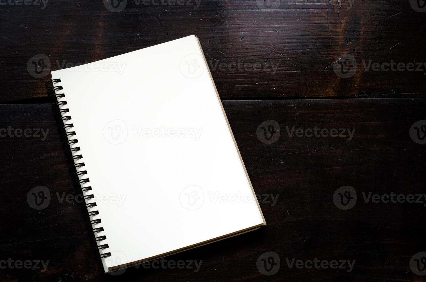 White notebooks laying on black table photo