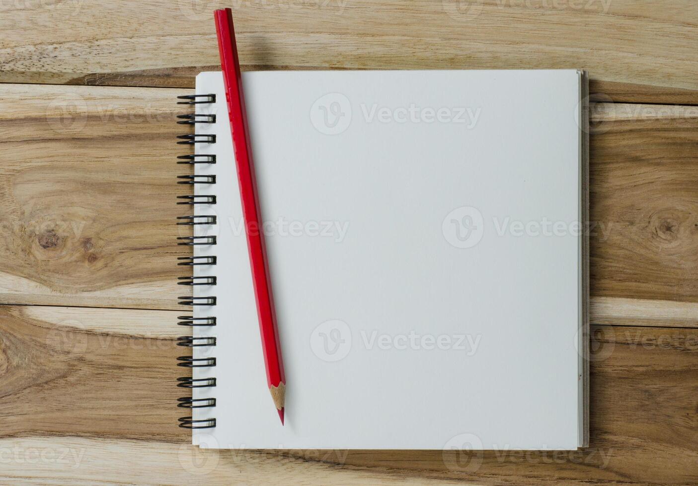 blank notebook with pencil on wooden table - still life photo