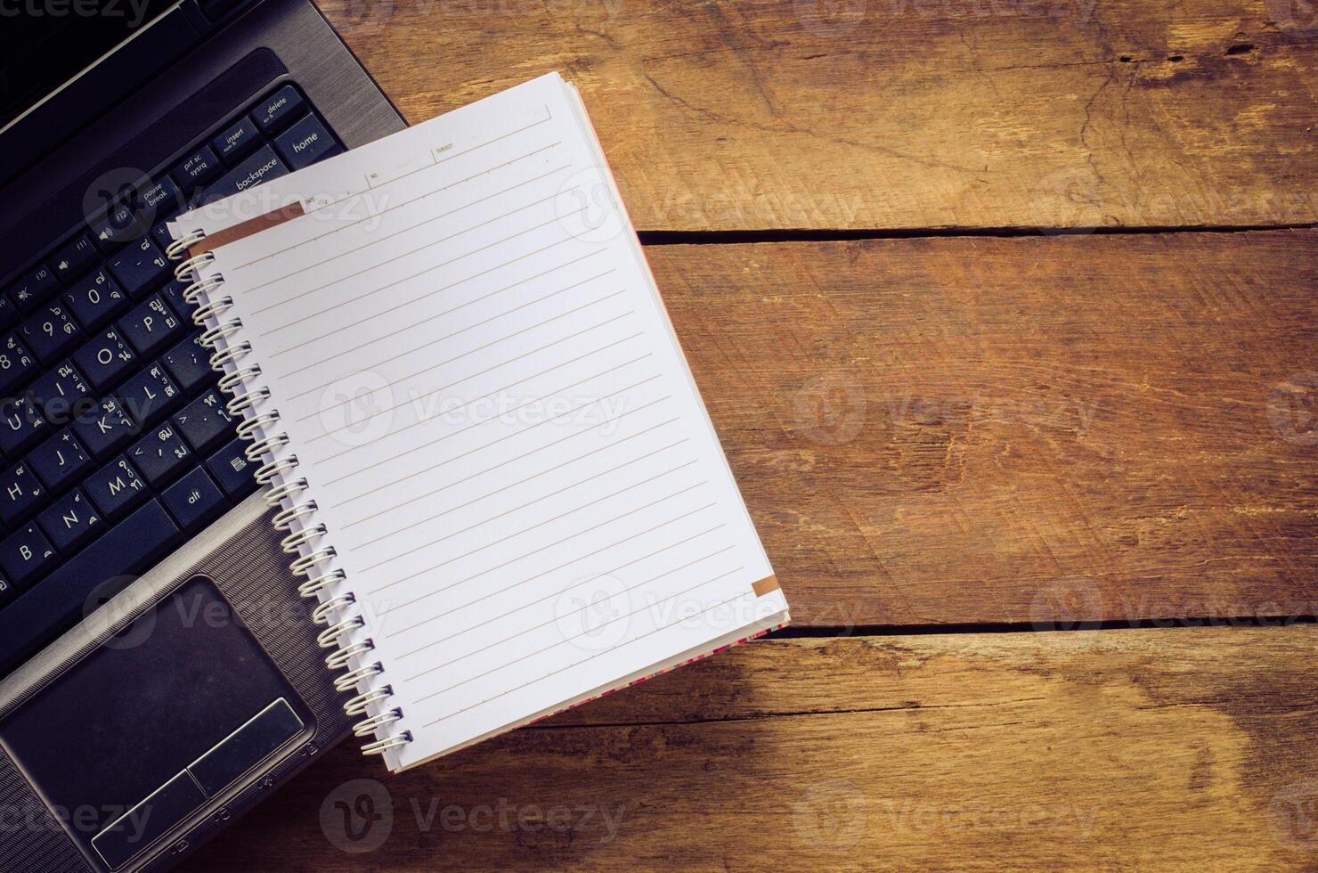 notebook on computer ,on wooden backgrould photo