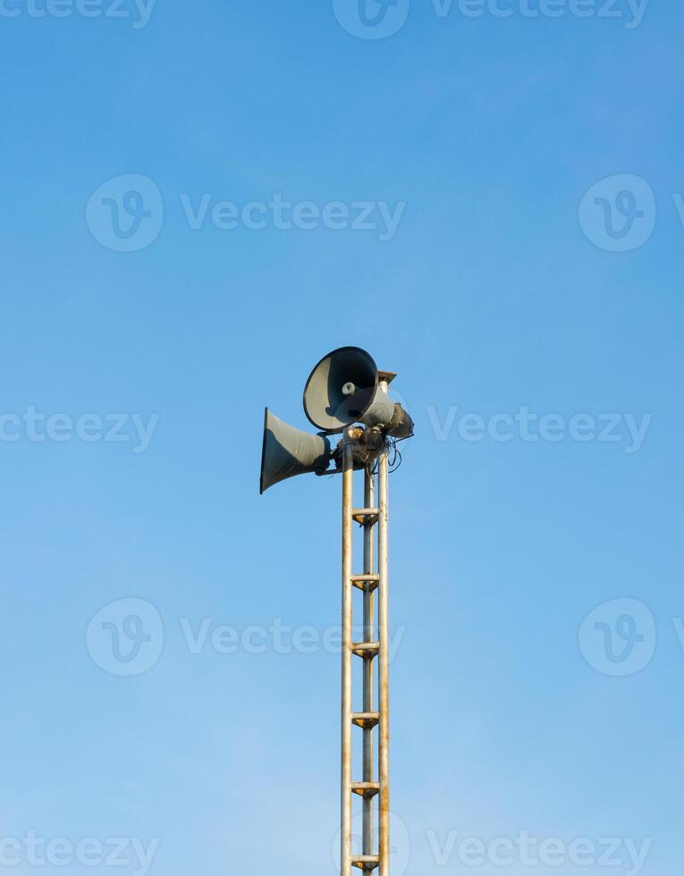 Loudspeaker Tower against Blue Sky Background photo