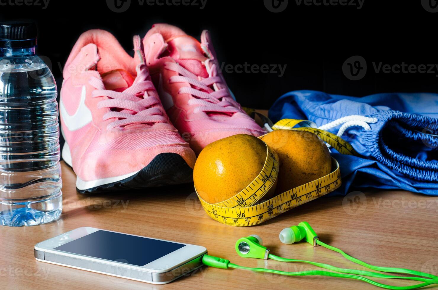 fitness concept with Exercise Equipment on wooden background. photo