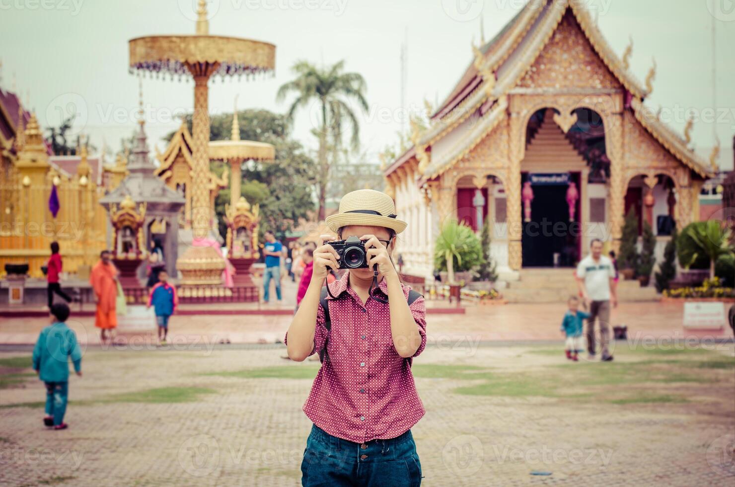 During the summer holidays outdoors girl having fun in the natural and cultural resources of the stylish, modern photographers with glasses and hat. photo