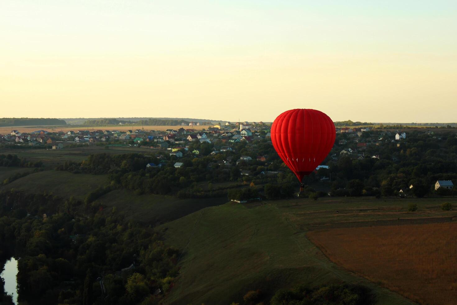 Hot air balloon over green fields photo