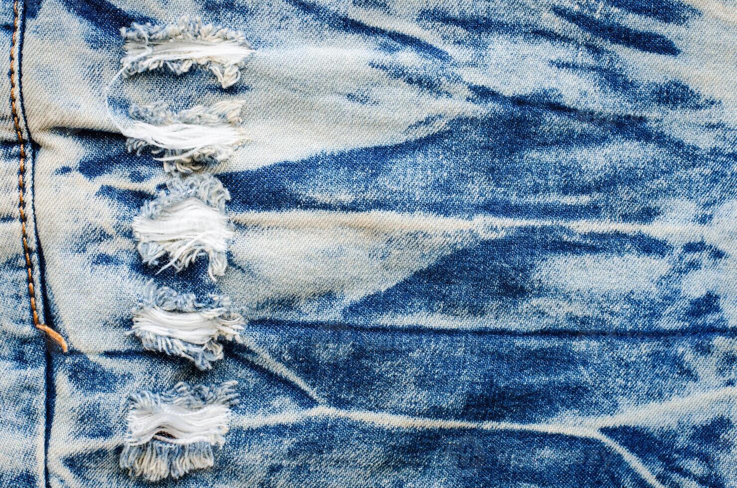 Wrinkles blue jeans texture. Jeans background. photo