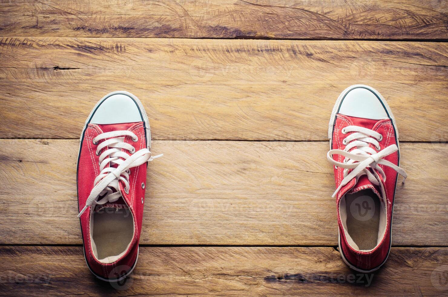 Red sneakers, put on the wood floor. photo