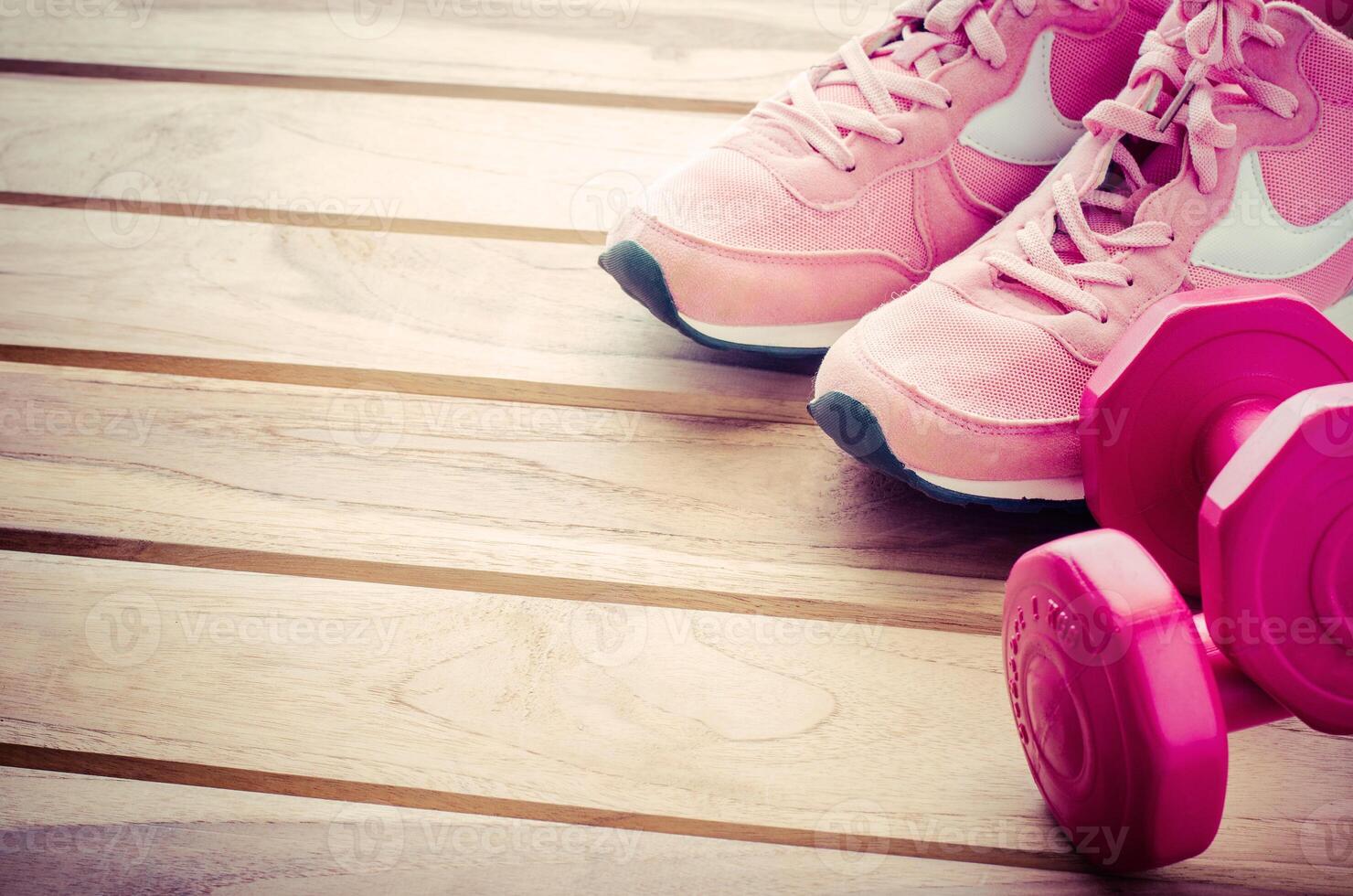 fitness concept with Exercise Equipment on wooden background. photo