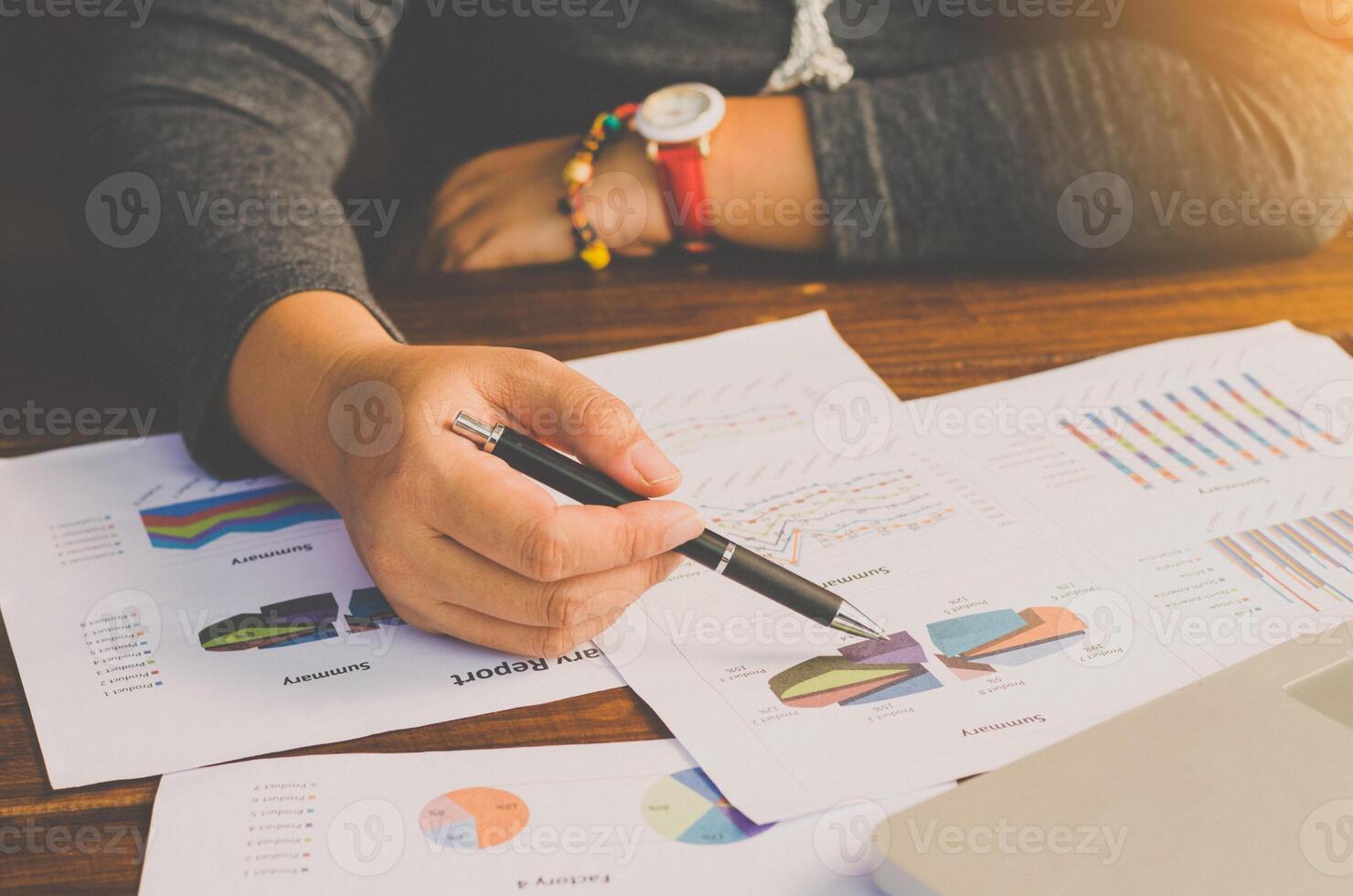 Businessman working on a desk numerical analysis, financial accounting. Graphing Calculator on laptop photo