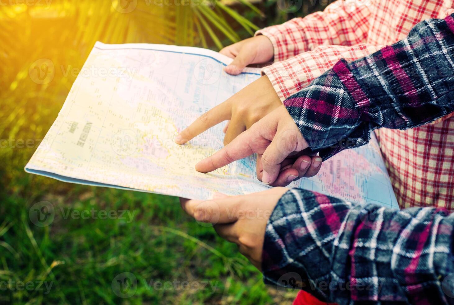 view of a young planning a journey looking at a map photo