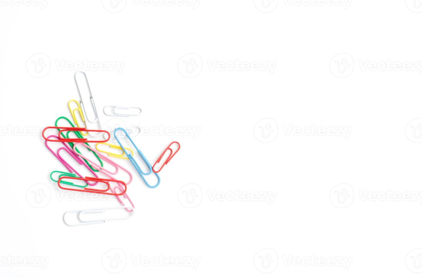 Colored paper clips on a white background. photo