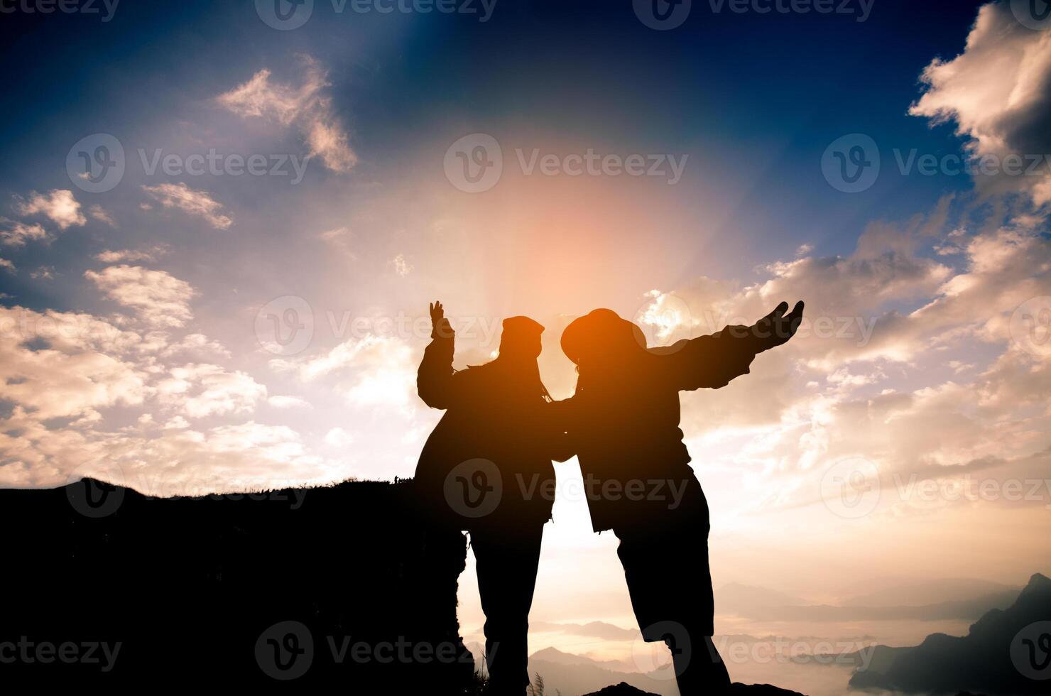 The silhouette of the tourists are happy to enjoy mountain scenery in the morning. photo