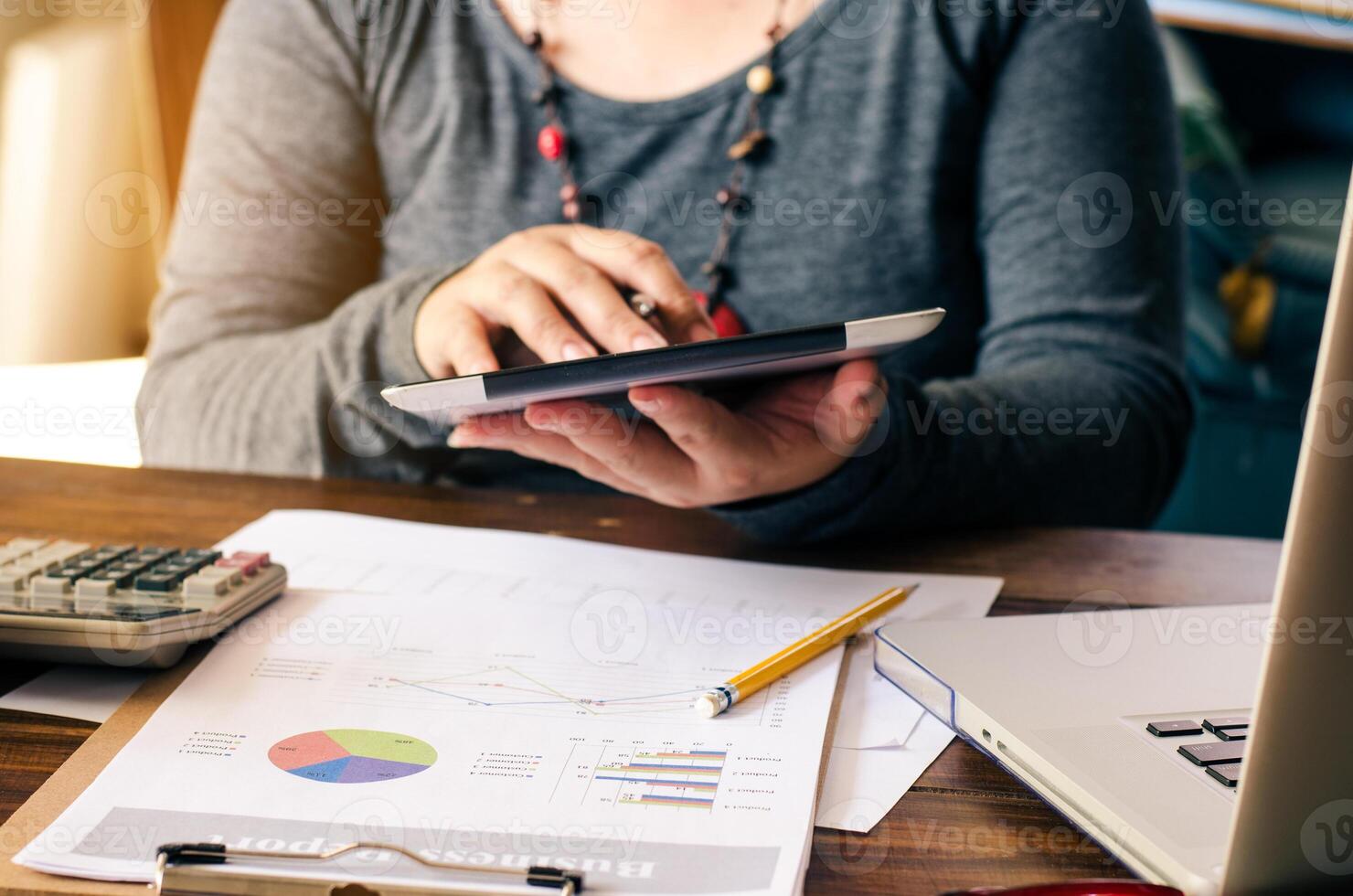 Working on a desk numerical analysis, financial accounting. Graphing on smartphone photo